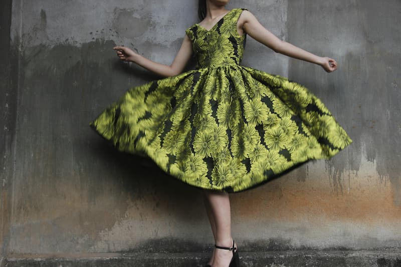 Woman in green dress twirling