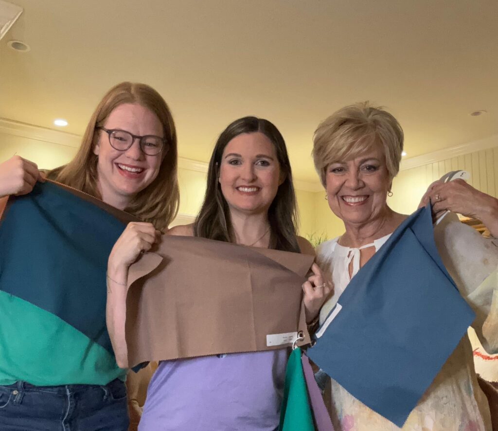 Barbara and two friends holding color drapes